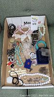 Full view of assorted costume jewelry in a box