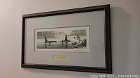 Framed print showing entire piece with mat and dark wood frame. Frame shows dings and scratches.