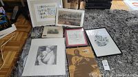 Overhead shot of multiple framed and unframed prints with a rolled scroll