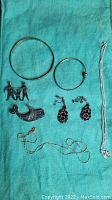 All eight jewelry pieces arranged on green background