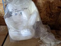 White Pillsbury Doughboy plush toy sealed in clear plastic labeled with SKU.