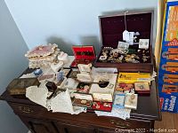 Wide view of table with jewelry boxes and assorted pieces