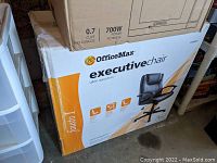 Box of OfficeMax executive chair showing brand, product name, and features
