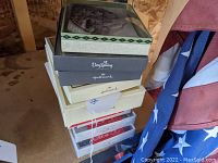 Photo of stacked boxes of unused greeting and holiday cards from various brands including Hallmark and Dayspring