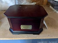 Top view of the music box showing the polished wooden lid and shape.