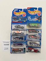 Photo of 10 Hot Wheels cars in original blister packs, various models lined up.