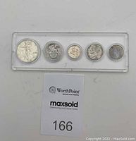 Five 1943 US coins in a transparent plastic holder: half dollar, quarter, zinc penny with copper coating, nickel, and dime.