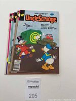 Stack of 5 Uncle Scrooge comic books showing front covers with colorful cartoon art featuring Uncle Scrooge and Donald Duck characters.