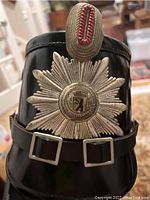 Front view showing silver star emblem with Berlin bear and red silver top ornament on the black helmet.