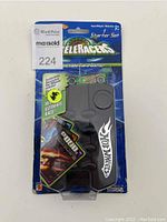 Two Hot Wheels AcceleRacers Two-Player Starter Card Game blister packs, each containing cards, play mat, and a 1:64 scale die-cast car. Packaging mostly intact with minor wear on corners.