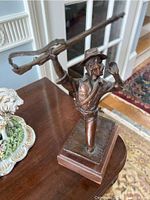 Front right three-quarter view showing figure kneeling and rifle raised