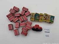 Photo of 25 film slide boxes grouped showing variety of series and some visible slide artwork, with Try-Vue viewer placed next to them.