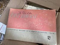 Front spiral-bound cover of the WWII 101st Airborne book showing title and embossed emblem.