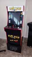 Front view of arcade cabinet showing marquee, screen and control panel