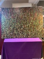 Full view of the large abstract acrylic painting showcasing the entire canvas with colorful squiggles and lines over a dark background.