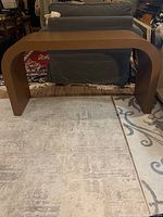 Front view of curved hall table showing U-shaped form