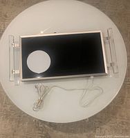 Top-down photo showing the entire electric buffet server with black top and lucite handles on both sides, including the detachable white power cord laid out in front.