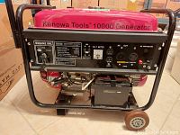 Front view showing Kenowa Tools label, engine switch, volt meter, AC/DC outlets and circuit breaker.