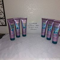 Six tubes of L'Oreal Paris Ever Pure sulfate-free shampoo, 8.5 fl oz each, arranged in two groups of three against a wall with a handwritten sign.