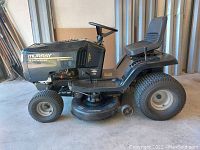 Left-side profile of mower showing overall condition, deck and tires