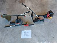 Overview of trimmer and all attachments laid on concrete floor