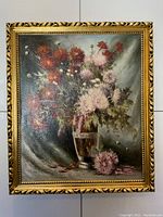 Full view of the large framed oil painting showing floral still life on canvas