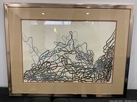 Front view of signed abstract watercolour painting in metallic frame showing full composition and framing details