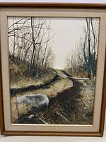 Front view of the framed oil painting showing the landscape scene with pathway and bare trees, plaque with artist name visible.