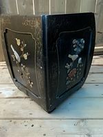 Square black lacquer stool with hardstone inlay floral and bird motifs on panels, with visible surface wear and scratches