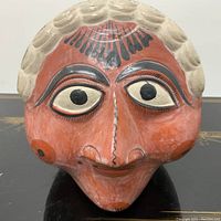 Front view of the Tonala hand-painted ceramic head showing detailed painted facial features and warm earth tones.