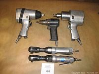 Full view showing 2 pneumatic impact wrenches, 2 ratchet wrenches, and 1 drill