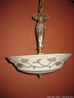 Side view showing frosted embossed floral glass shade and ribbed clear glass stem hanging light fixture