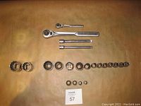 Full set laid out on flat surface, showing ratchets, sockets, and extensions.