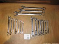 Photo showing the complete set of gear wrenches arranged on a table surface with a MaxSold lot number card visible.