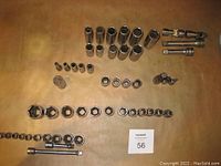 Top-down view of all Snap-on sockets, extensions, and universal joints spread out for inventory.