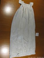 Full view of the vintage baby christening gown laid flat showing overall length and shape