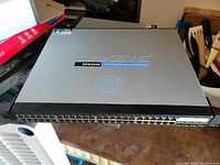 Front view of Linksys SRW2048 48 Port Managed Gigabit Switch showing ports and model label.