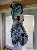 Full view of the pole topper display showing Miami Heat basketball player cutout and Miller Lite logo.