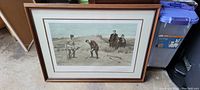 Framed art print showing a golf scene with four men and a dog on a golf course, housed in a wood frame with glass.
