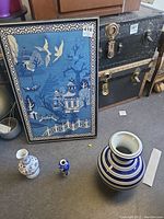 Photo of whole lot showing framed wall art and four ceramic vases