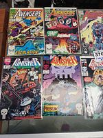 Photo showing issues of Avengers and The Punisher comics including Avengers comic book with 'Escalation!' storyline.