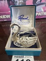 Close-up of silver swan sugar dish inside Raimond branded box