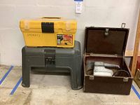 Full view of yellow Omega socket set toolbox on top of Rubbermaid step stool toolbox next to Craftsman sander in open brown wooden case