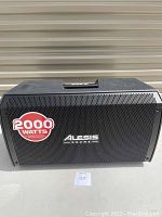 Front view showing metal grille with Alesis Drums logo and 2000W sticker