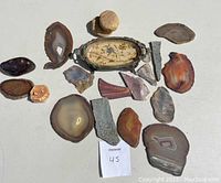 Overview of lot with all vintage sliced stones and mini jewelry dish arranged on white backdrop showing size and color variety.