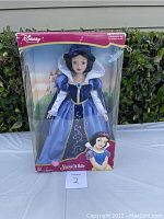 Front view of Disney Snow White doll in original packaging with box showing some wear.
