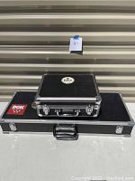 Photo showing two stacked metal electronics cases, black with metal edging, carrying handles and locks