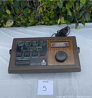 Front view of Atari Video Pinball game controller with woodgrained control panel and button layout.