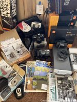 Wide view of lot showing cameras, slide trays, scanner, bags and tripod box