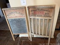 Front view of two antique washboards, one Sunnyland and one National Washboard Co., side by side.